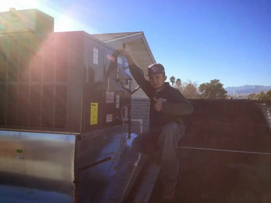 HVAC technician performing HVAC Inspection on a rooftop unit in Albuquerque